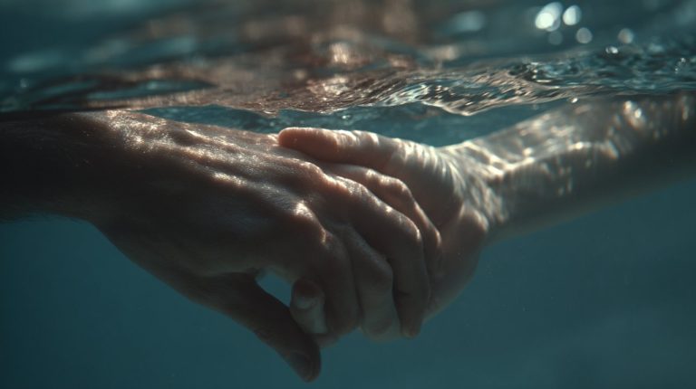 Two hands gently touching underwater, symbolizing trust and emotional depth.